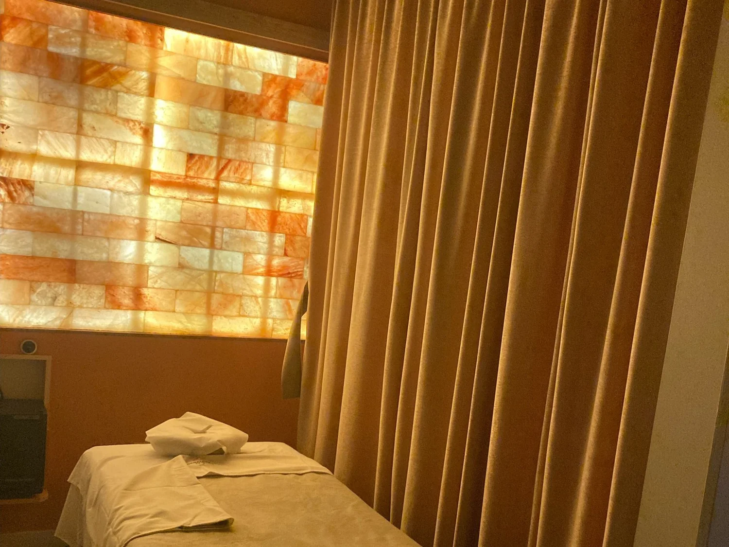 A private massage room at Serenity Zen Diamond Bar, one table beside a backlit salt wall