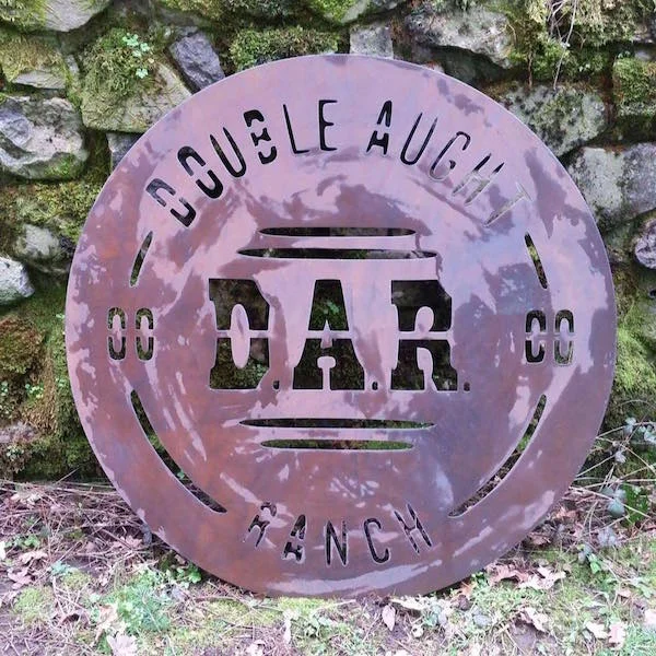 Plasma cut metal sign featuring original logo designed by Patey Designs for Double Aught Ranch