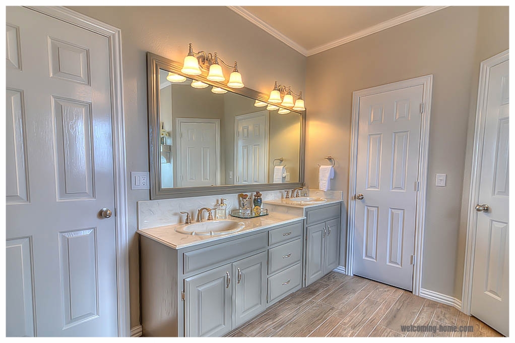  Painted cabinets, new fixtures, hardware, framed mirror, lighting, door added for privacy 