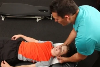 Chiropractor treating a young boy.jpg