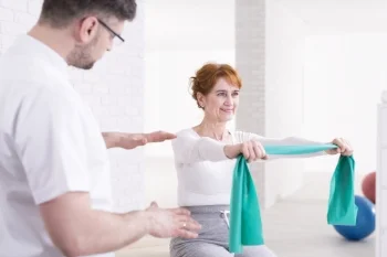 Chiropractor w senior patient elastic band.jpg