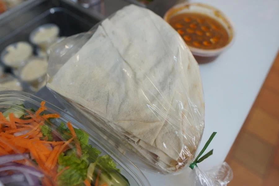 Fresh pita bread on cutting board at ANI Catering, Belmont MA