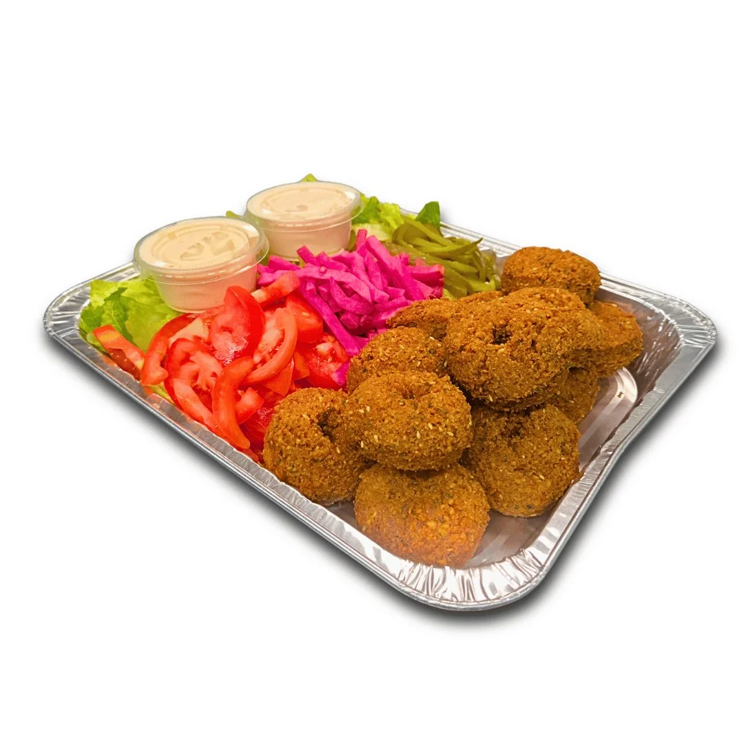 Falafel catering tray with tahini, tomato, pickled turnip