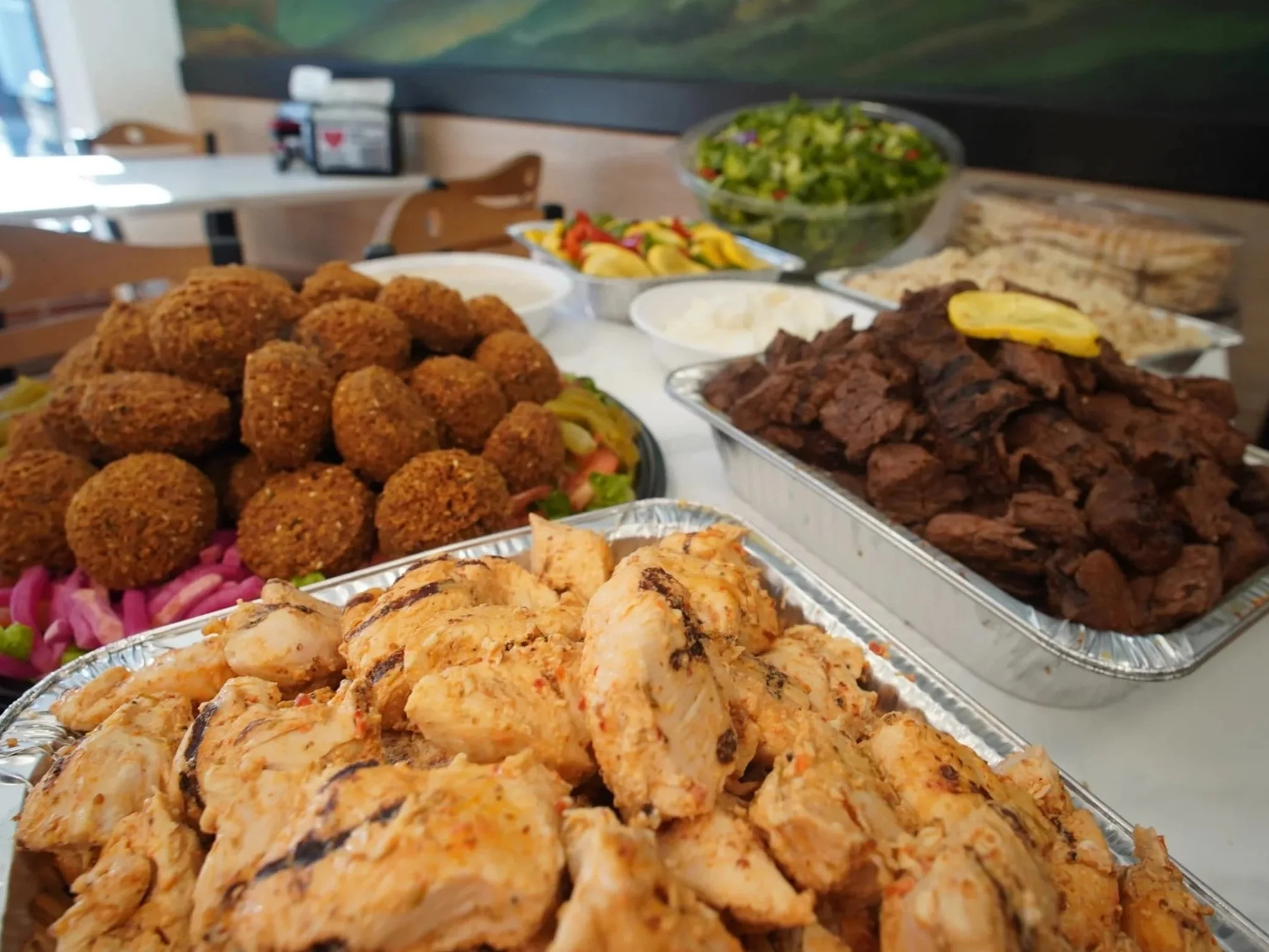 ANI Catering halal food catering buffet spread — grilled halal chicken kabob and shawarma, beef kabob, falafel platter, tabbouleh, and roasted vegetables served in Greater Boston