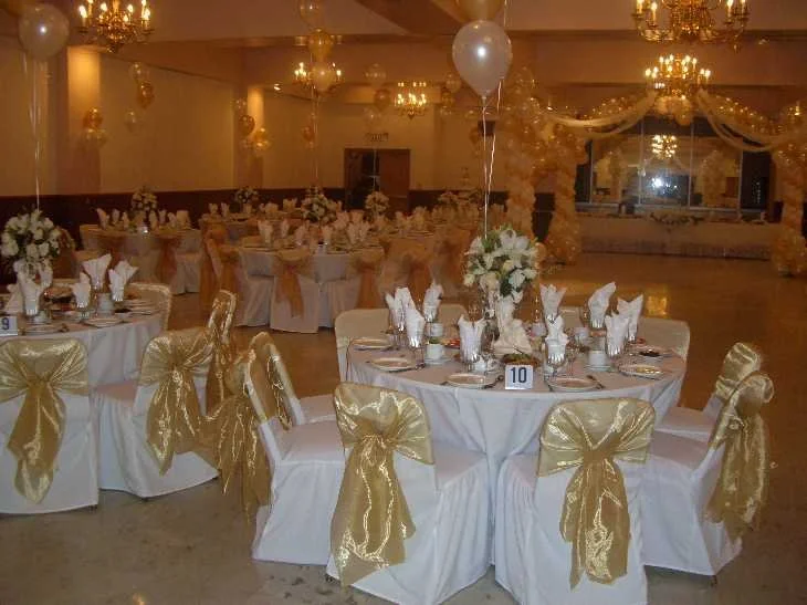 ANI Catering elegant christening baptism ballroom with gold chair sashes and white linen tables in Belmont MA