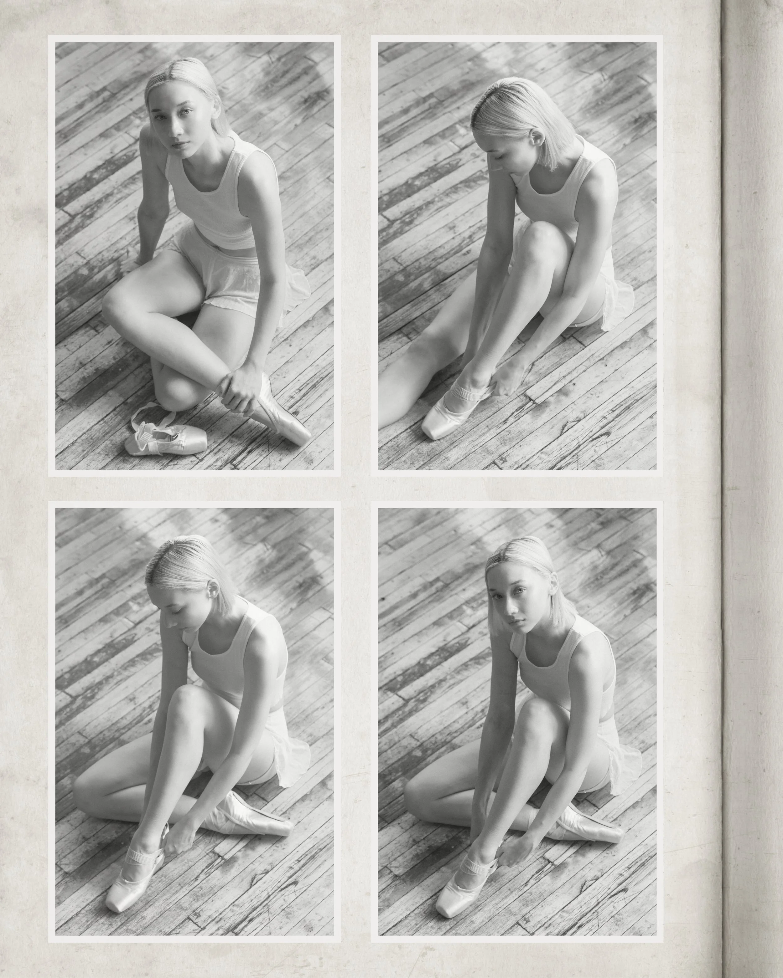 Black and white photo of a young woman with short blonde hair sitting on a wooden floor, putting on ballet shoes.