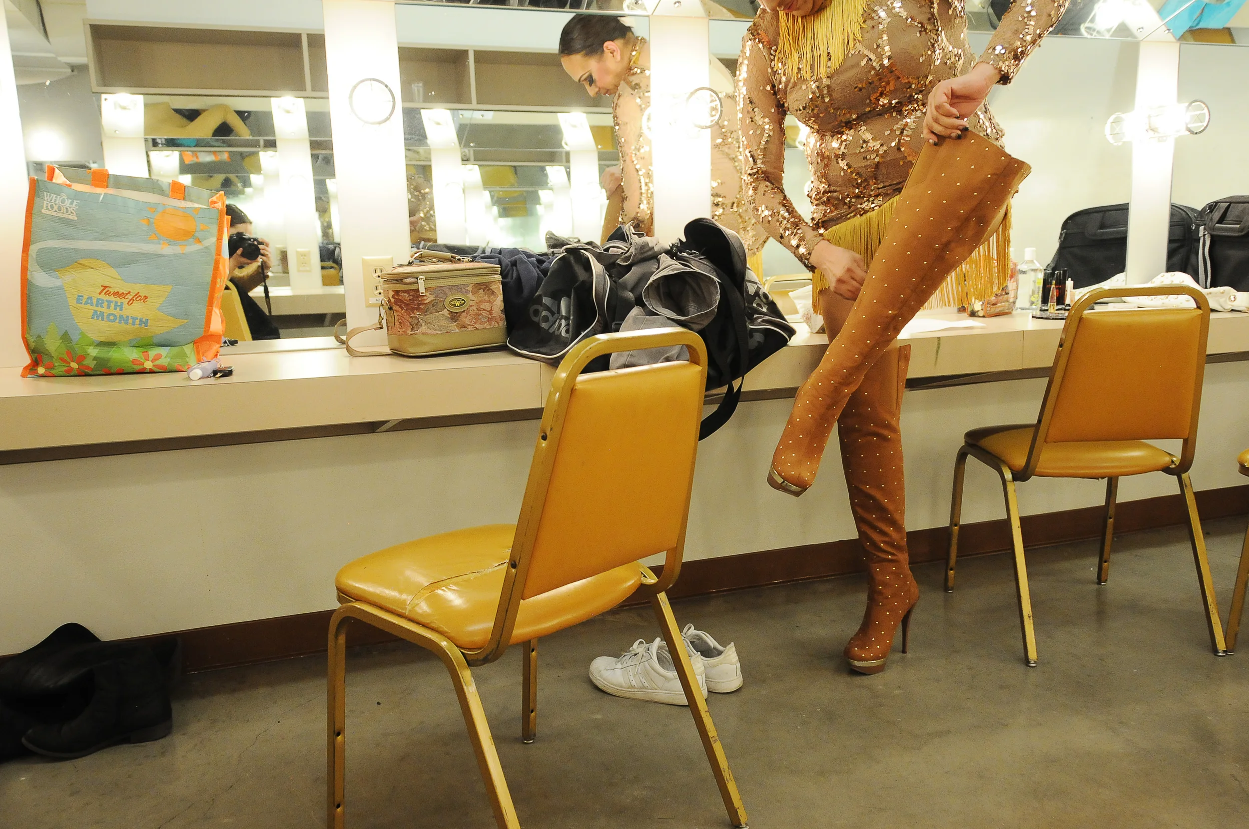 A drag queen zips up her boots before the annual University of Washington Drag Competition in Seattle, Washington. April 2013.