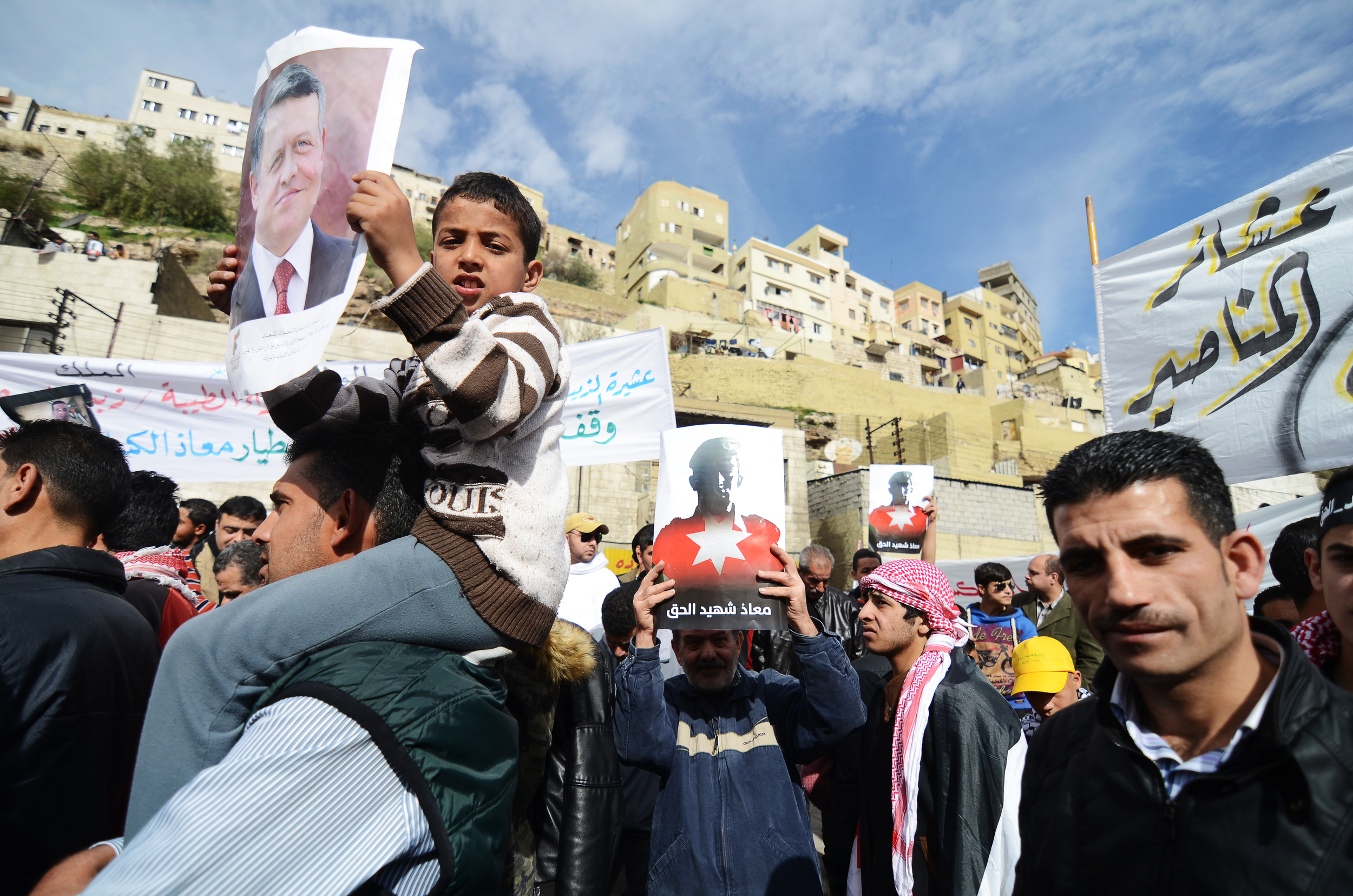 A Jordanian child holds a poster of Jordan's King Abdullah II during Amman's solidarity demonstration, one of the largest the country's seen in years. February 2015. 
