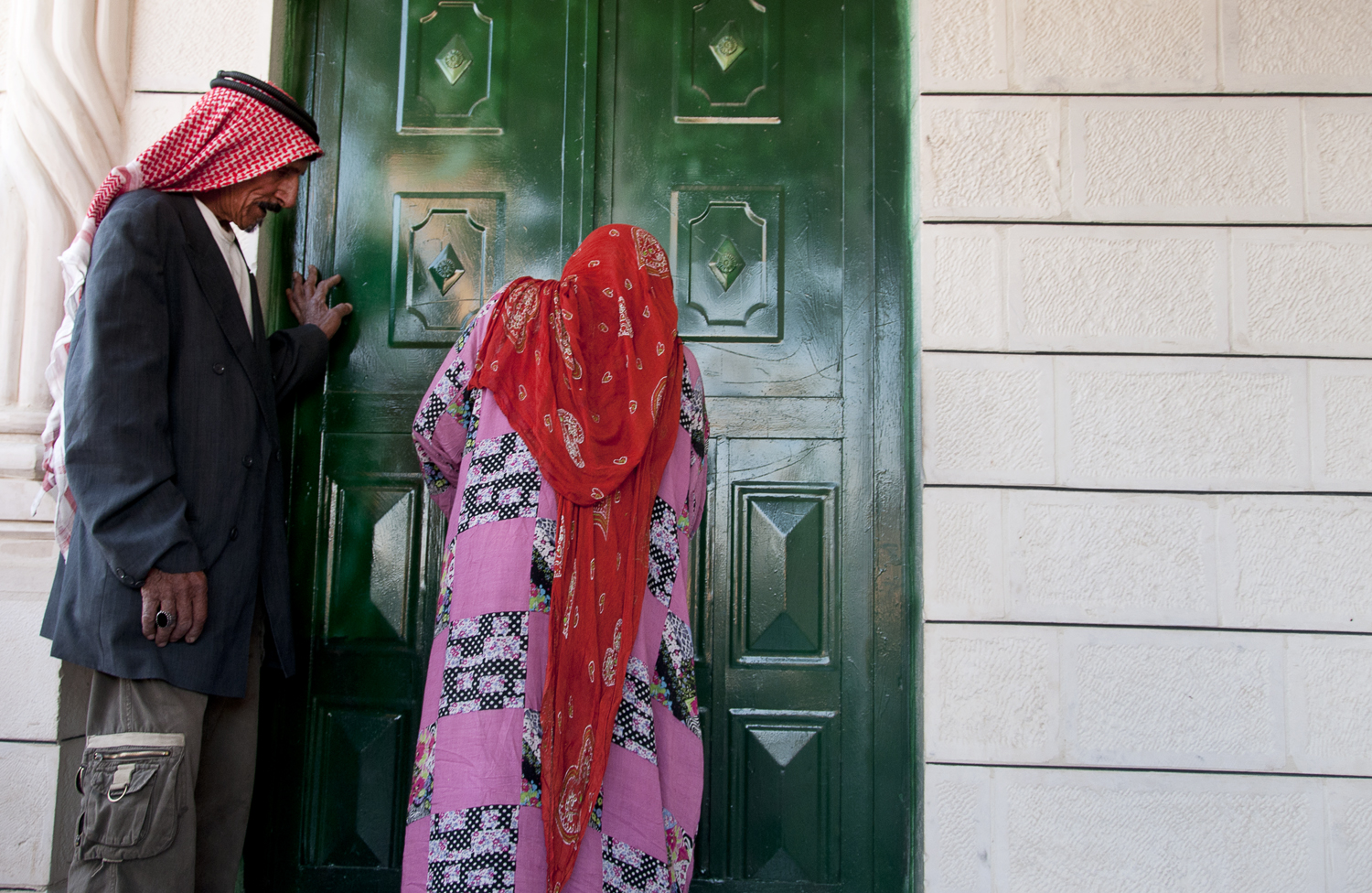 Abu Husain and his wife enter their home in the outskirts of Amman. While the Bani Murra are regarded as nomadic passersby by their fellow Jordanian countryman, tribal leaders claim historic ties to the country dating back to 1860. July 2013. 