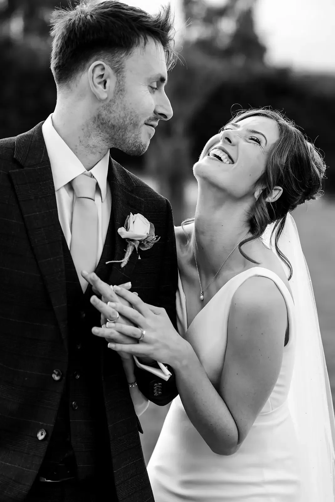 Black and White image of the bride and groom laughing at Cain Manor