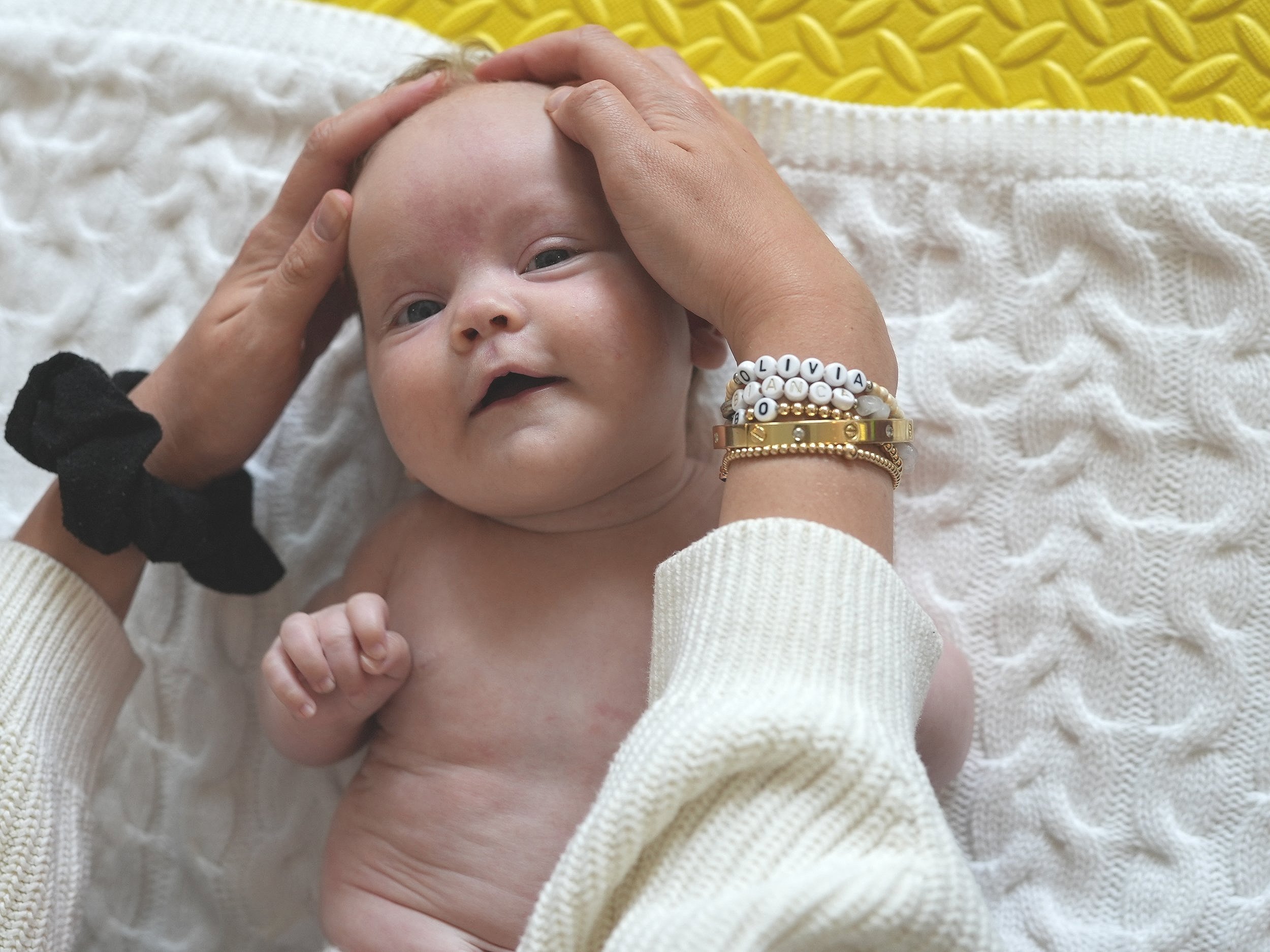  Baby girl is having her head gently massaged by mum. This stroke is called shampooing 