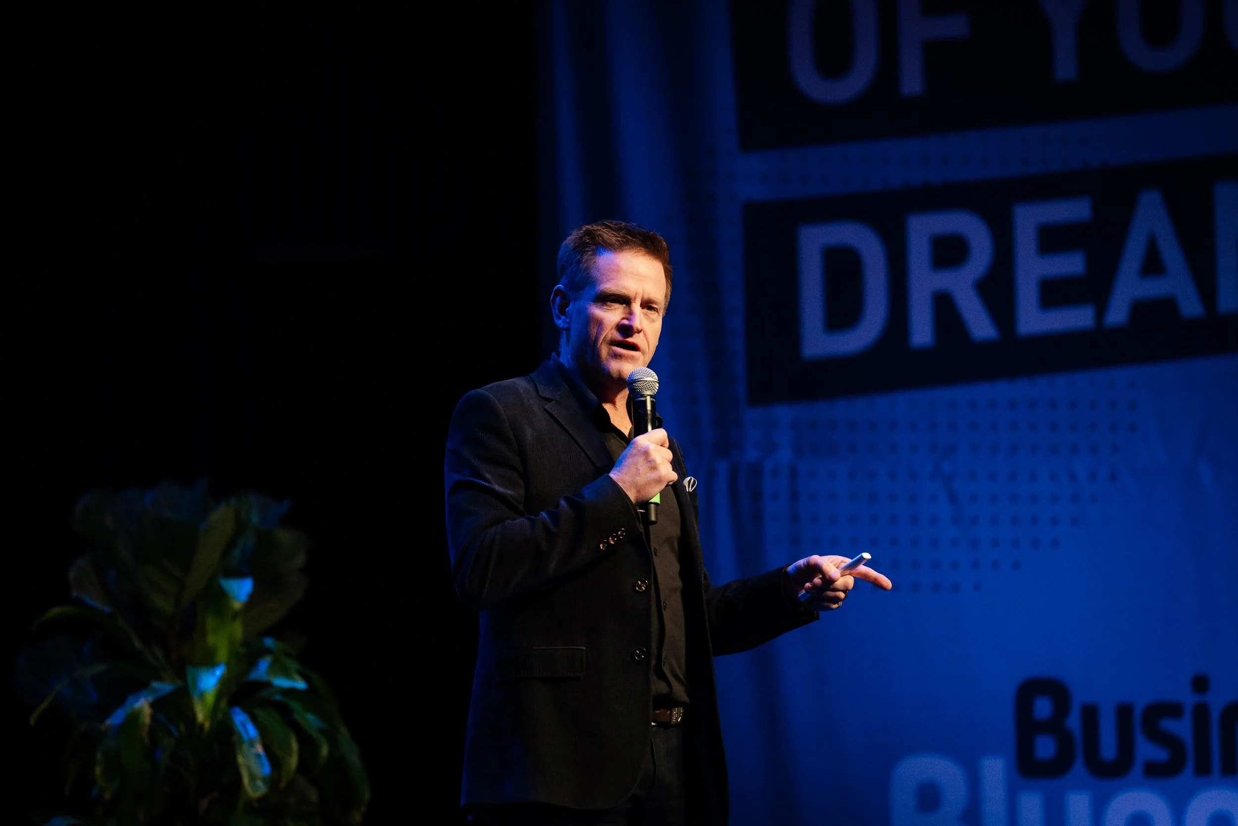 Peter Baines OAM speaking on stage