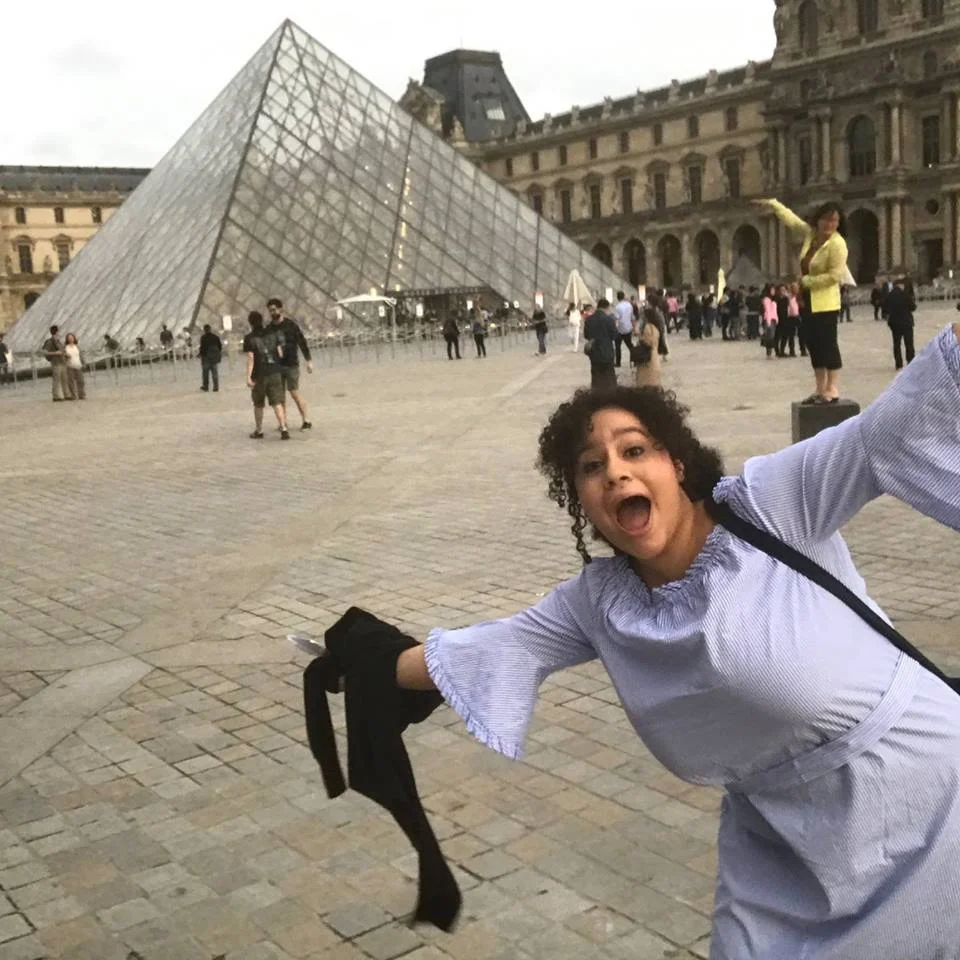 Veronica being a tourist. No word on whether she brought homework to the Louvre. 