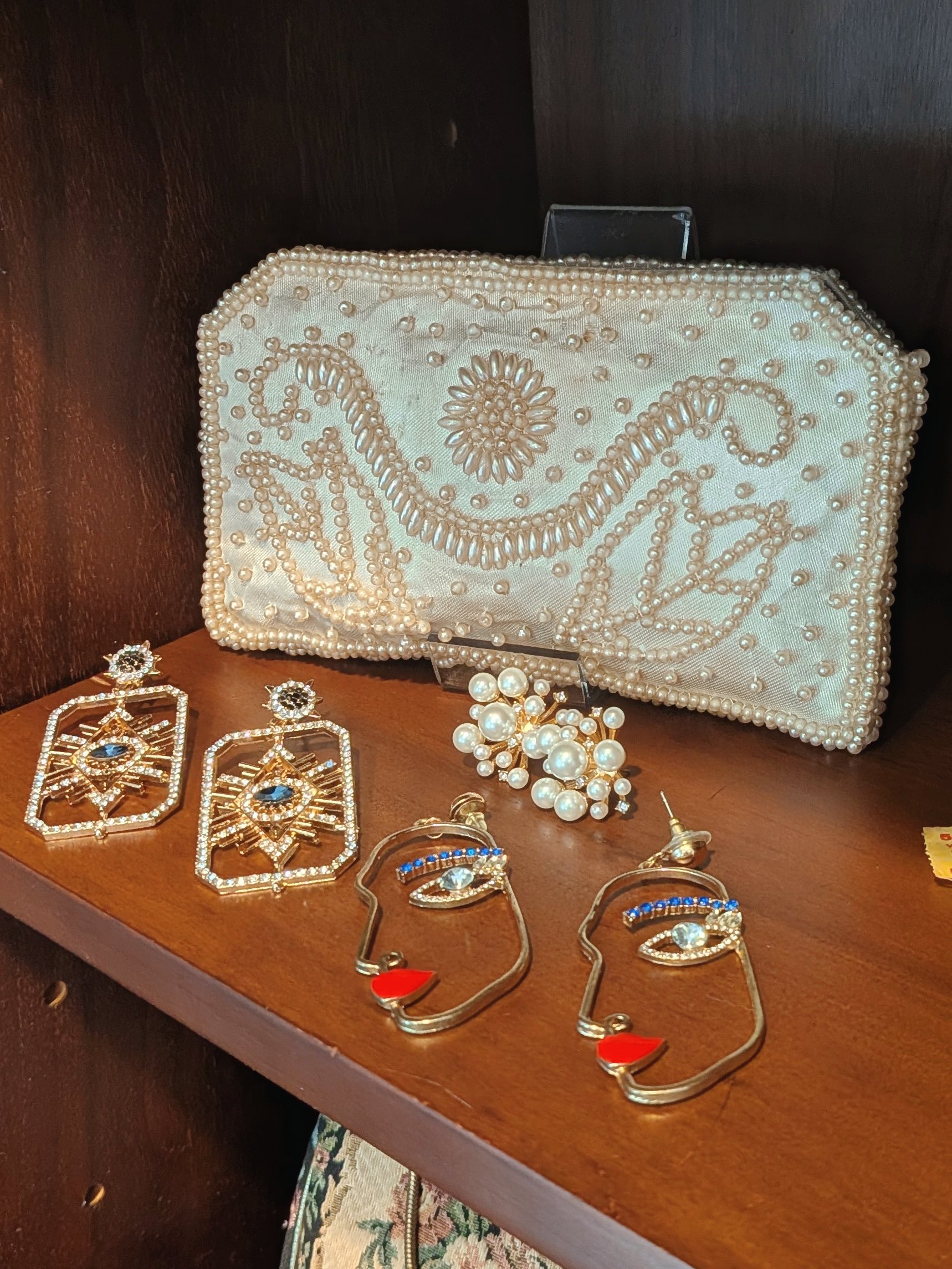 Vintage bridal accessories displayed in a couture studio, featuring pearl details and beaded elegance.
