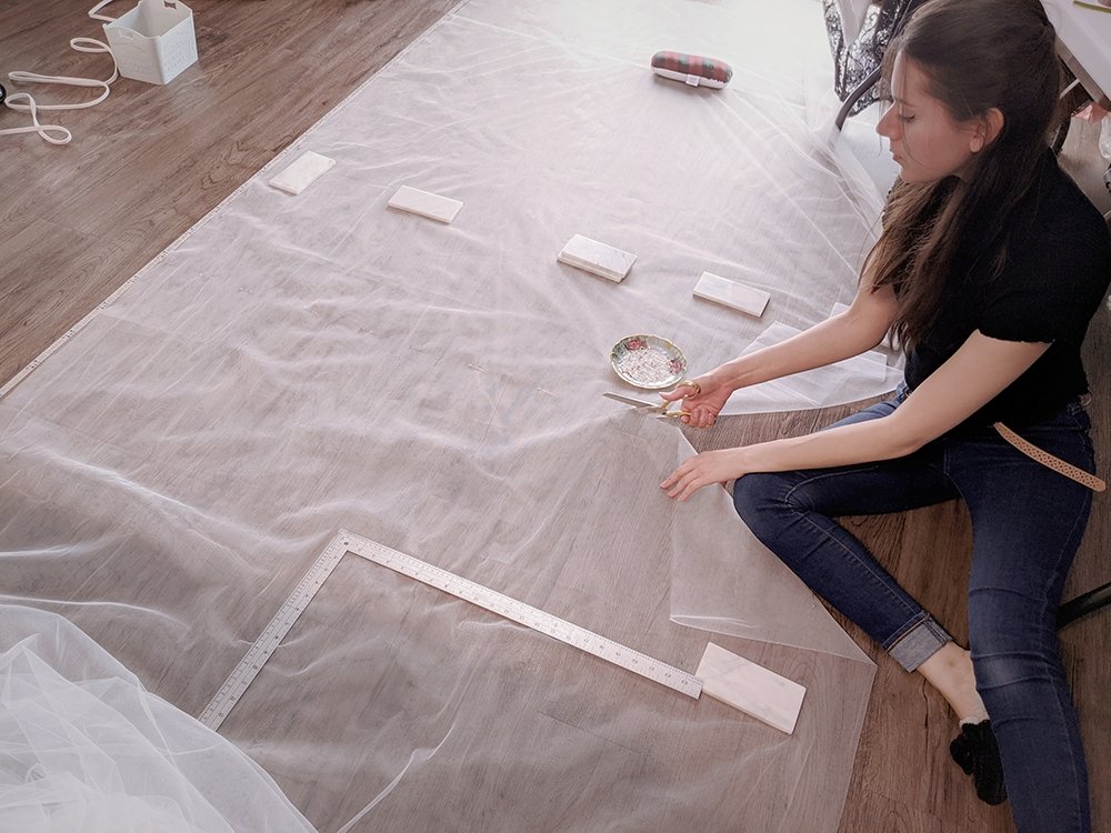 dressmaker Jessica cutting a custom veil for a bride