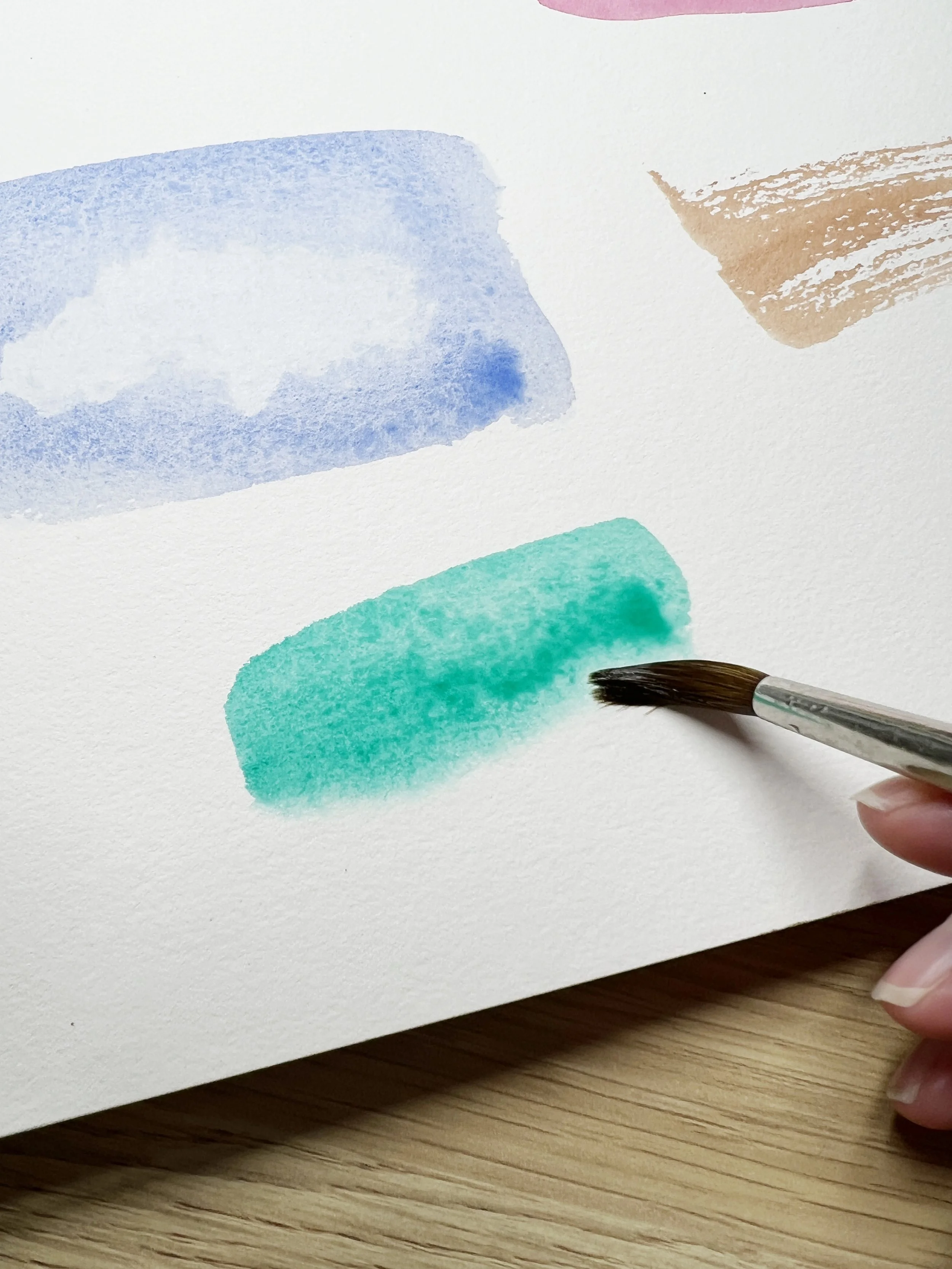Example of wet on wet watercolour wash showing soft blended edges in blue and green on textured watercolour paper