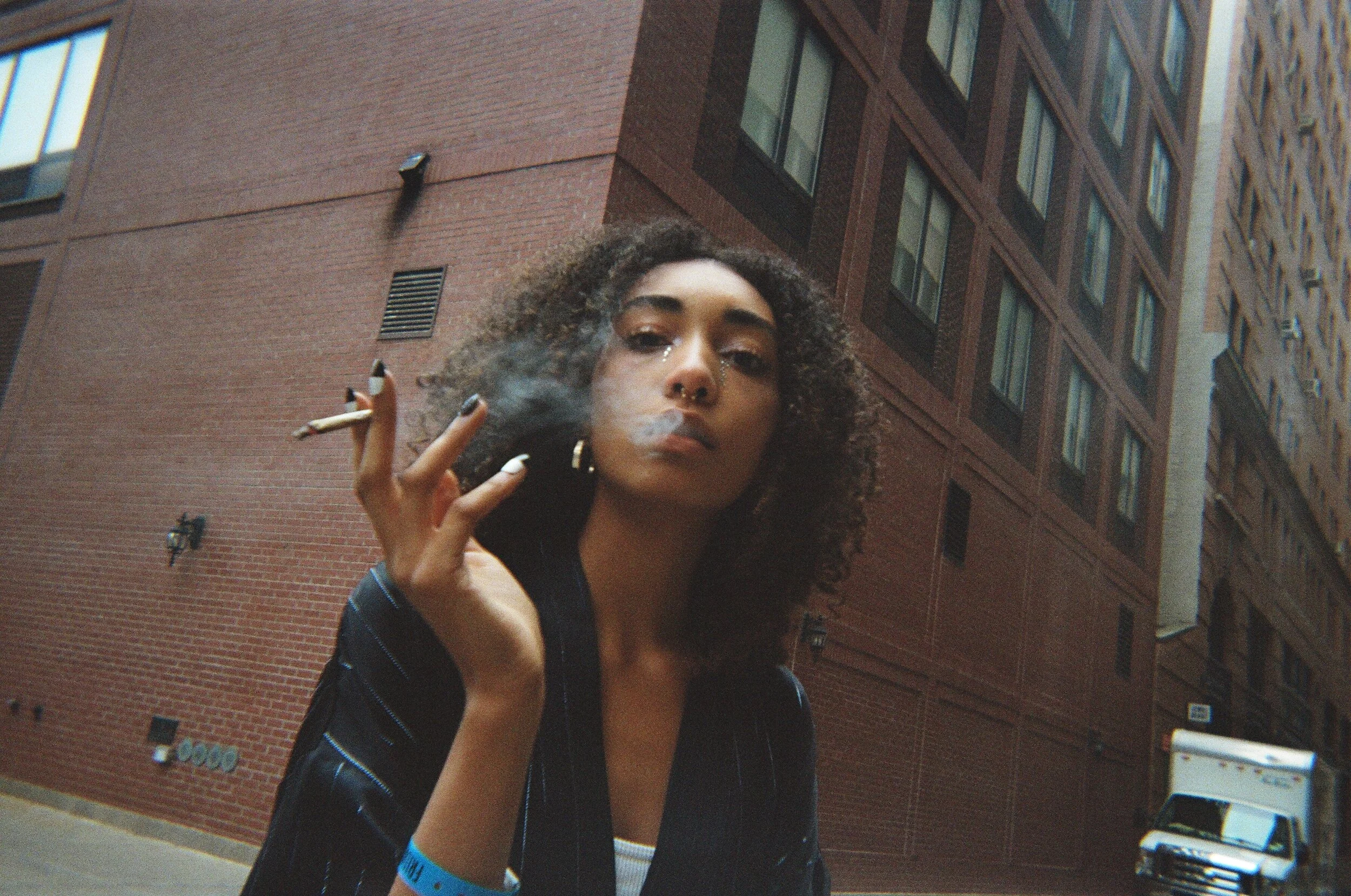 Moody film portrait of model smoking cigarette