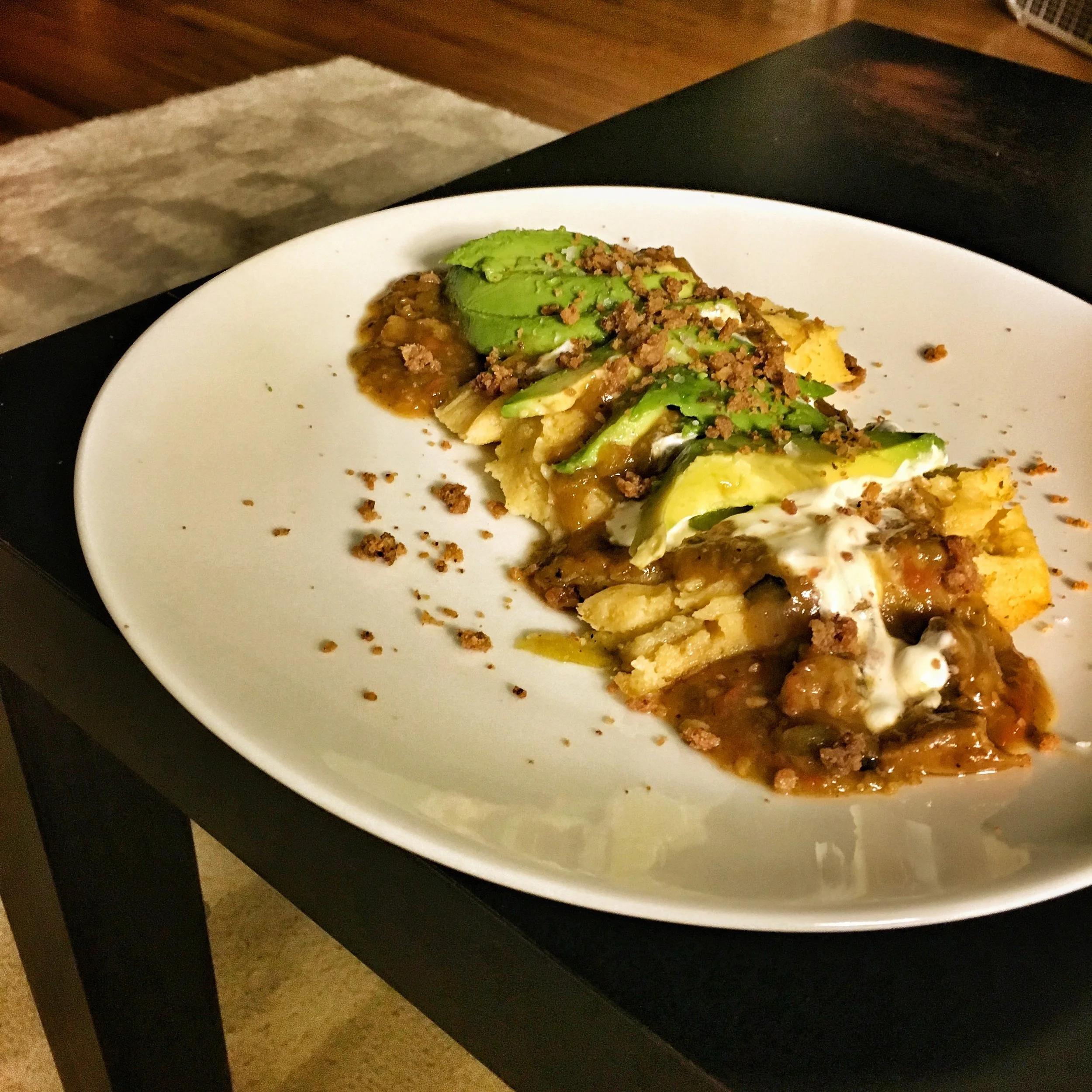 Tamales smothered with pork green chili, sour cream, avocado; topped with pork cracklings.