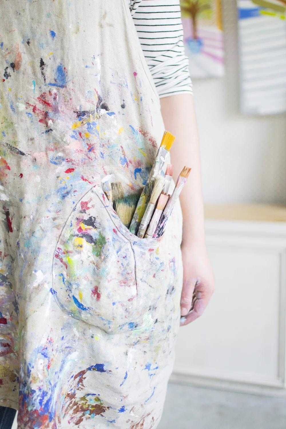 paintbrushes in smock pocket.jpg