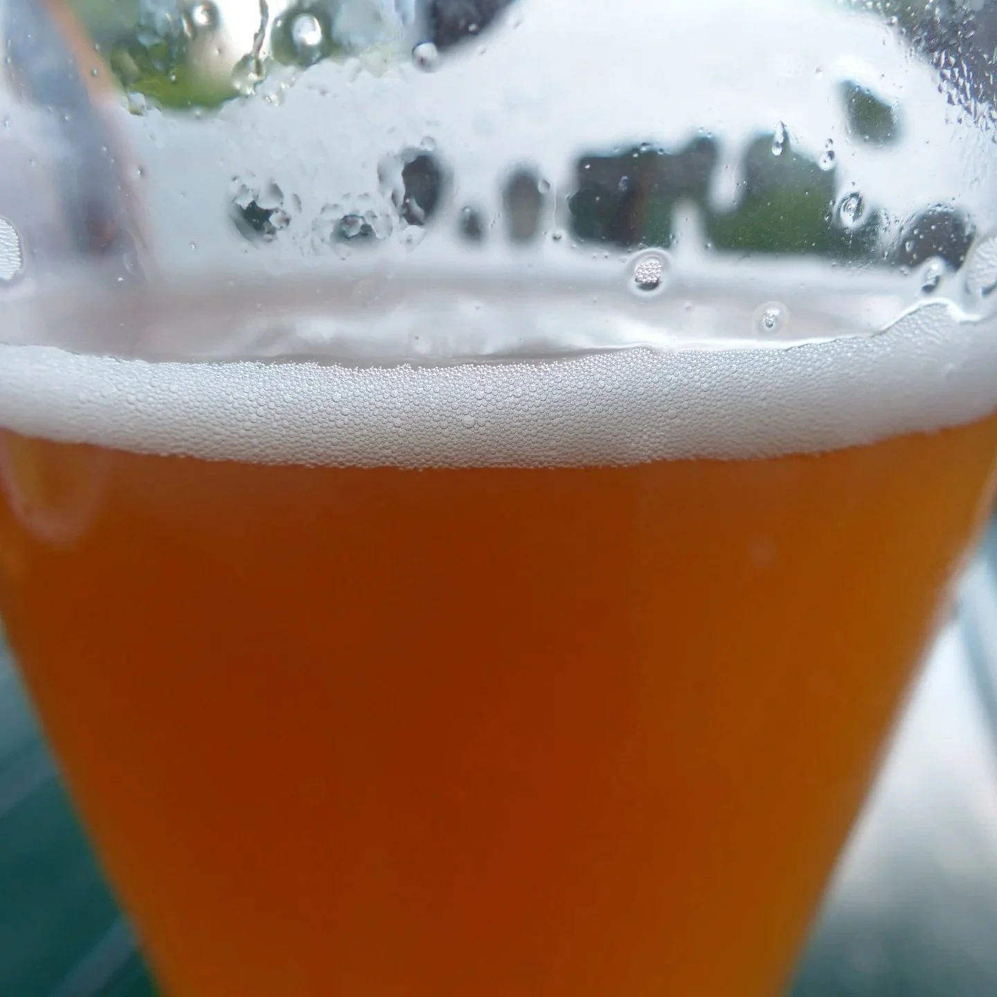 Close-up picture of copper beer with white foam