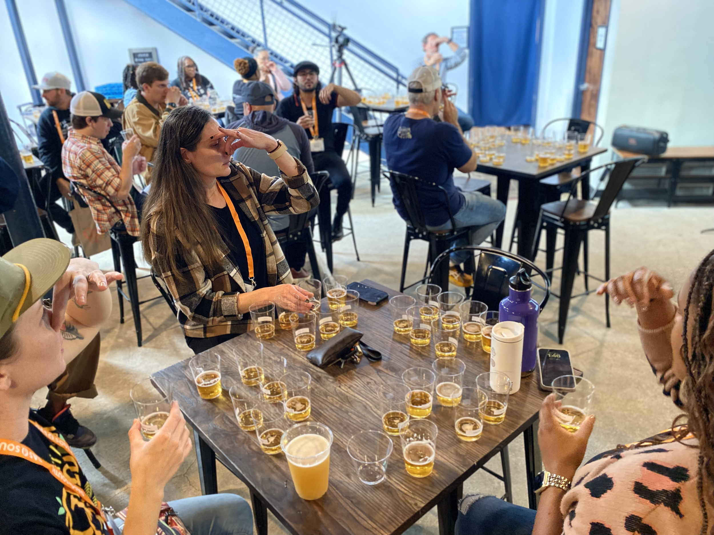 People holding their noses while sampling pale beer samples