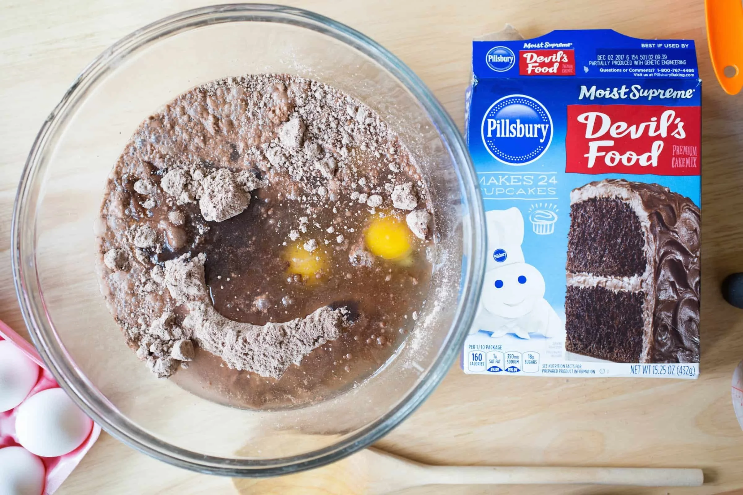 Close up of Pillsbury Devils Food cupcake mix and bowl with cupcake ingredients