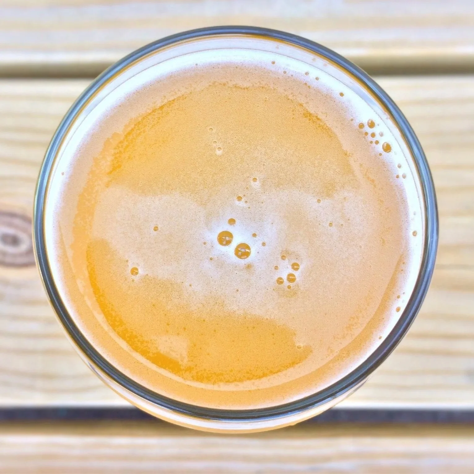Close-up of golden beer shot from above