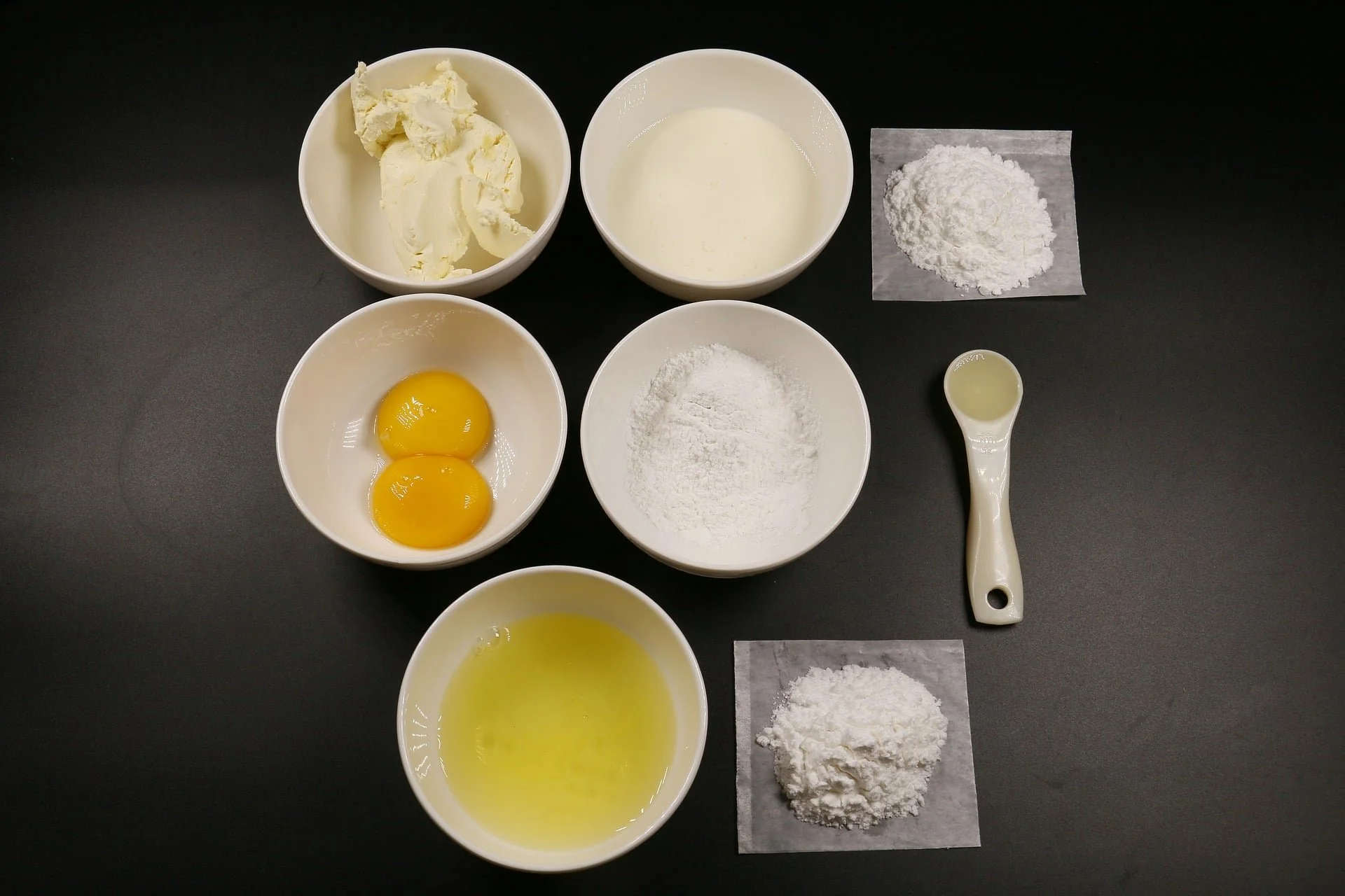 Baking ingredients on black background