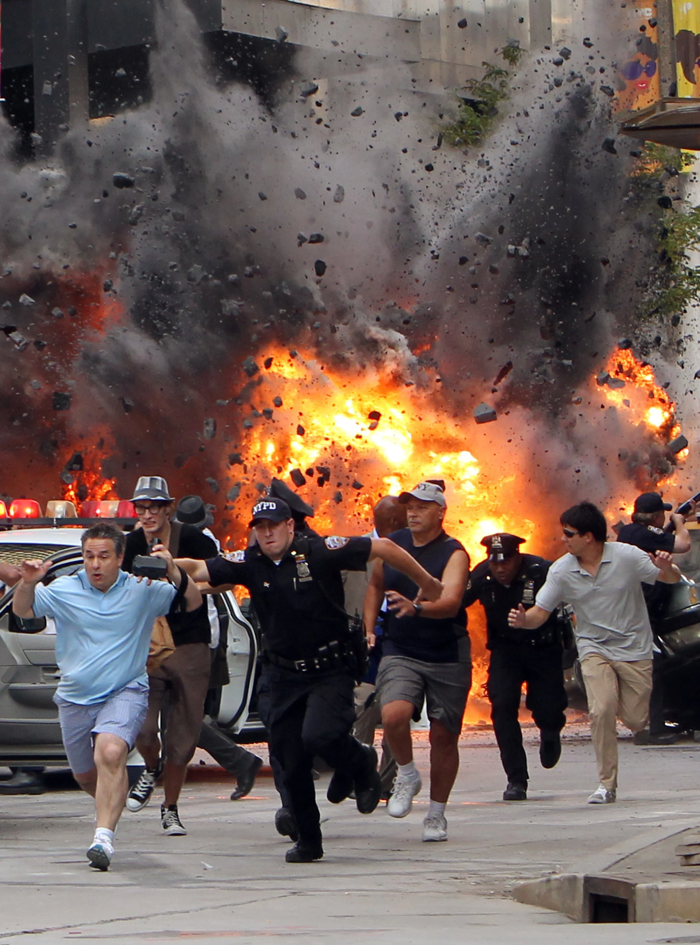  Movie extras run from explosions during special effects filming of The Avengers movie, Monday, Aug. 15, 2011, in Cleveland.  The intersection of Euclid Avenue and E9th Street in Cleveland, was made to look like the area outside New York's Grand Cent