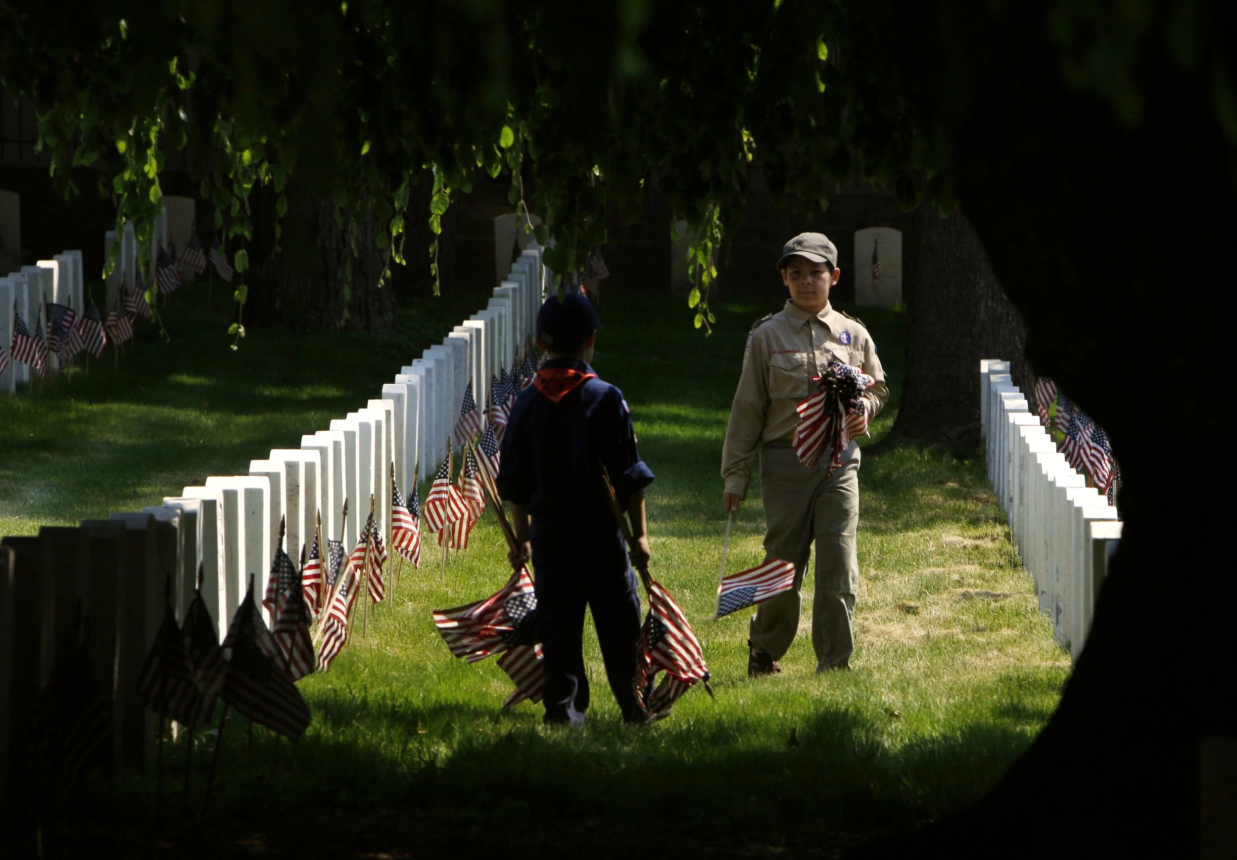  Cub Scouts decorate the graves of fallen American soldiers for Memorial Day with flags at Cypress Hills National Cemetery in the Brooklyn borough of New York Saturday, May 23, 2009. 