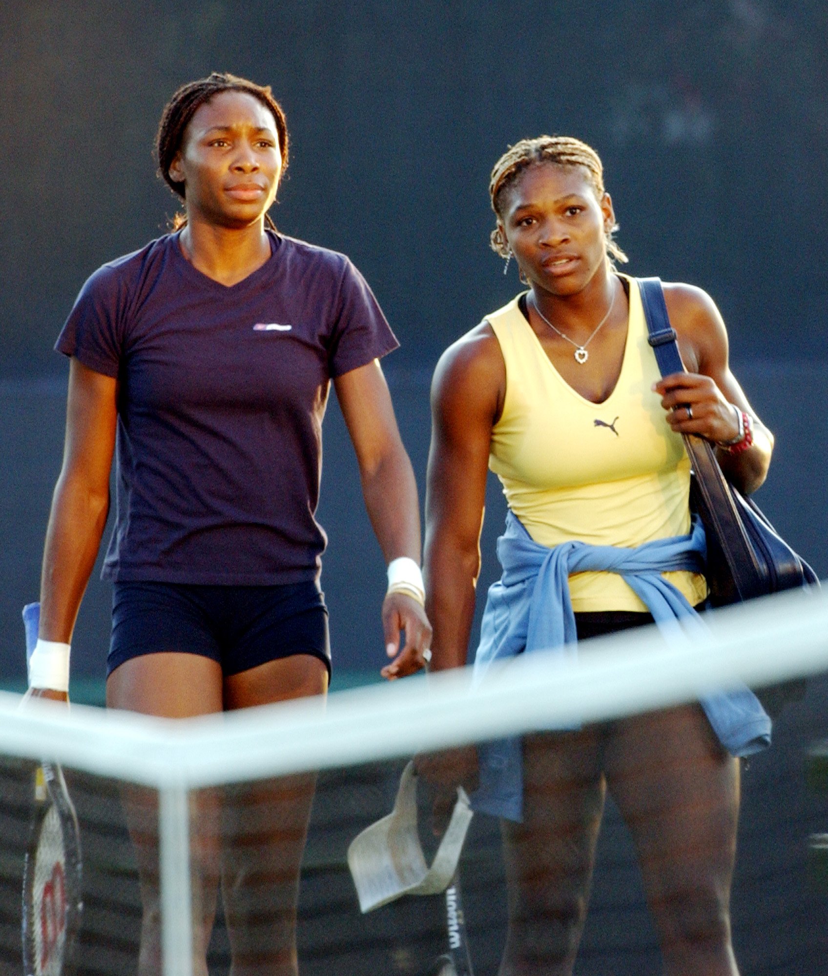  Venus, left, and Serena Williams walk off a practice court before their scheduled women's final in the US Open Saturday, Sept. 8, 2001 in New York. This is the first time the sisters will play against one another in a grand slam final. 