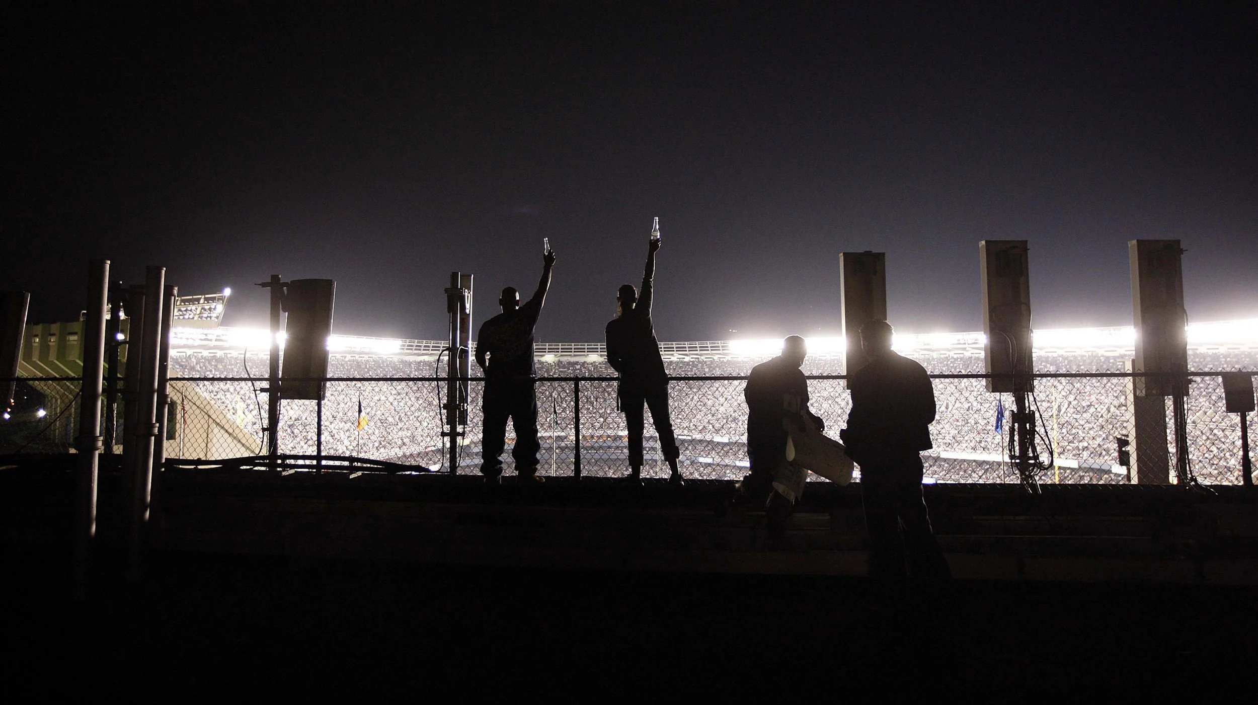  Fans cheer from a Bronx rooftop overlooking Yankees Stadium during the last home game in the House That Ruth Built, Sept. 21, 2008. 