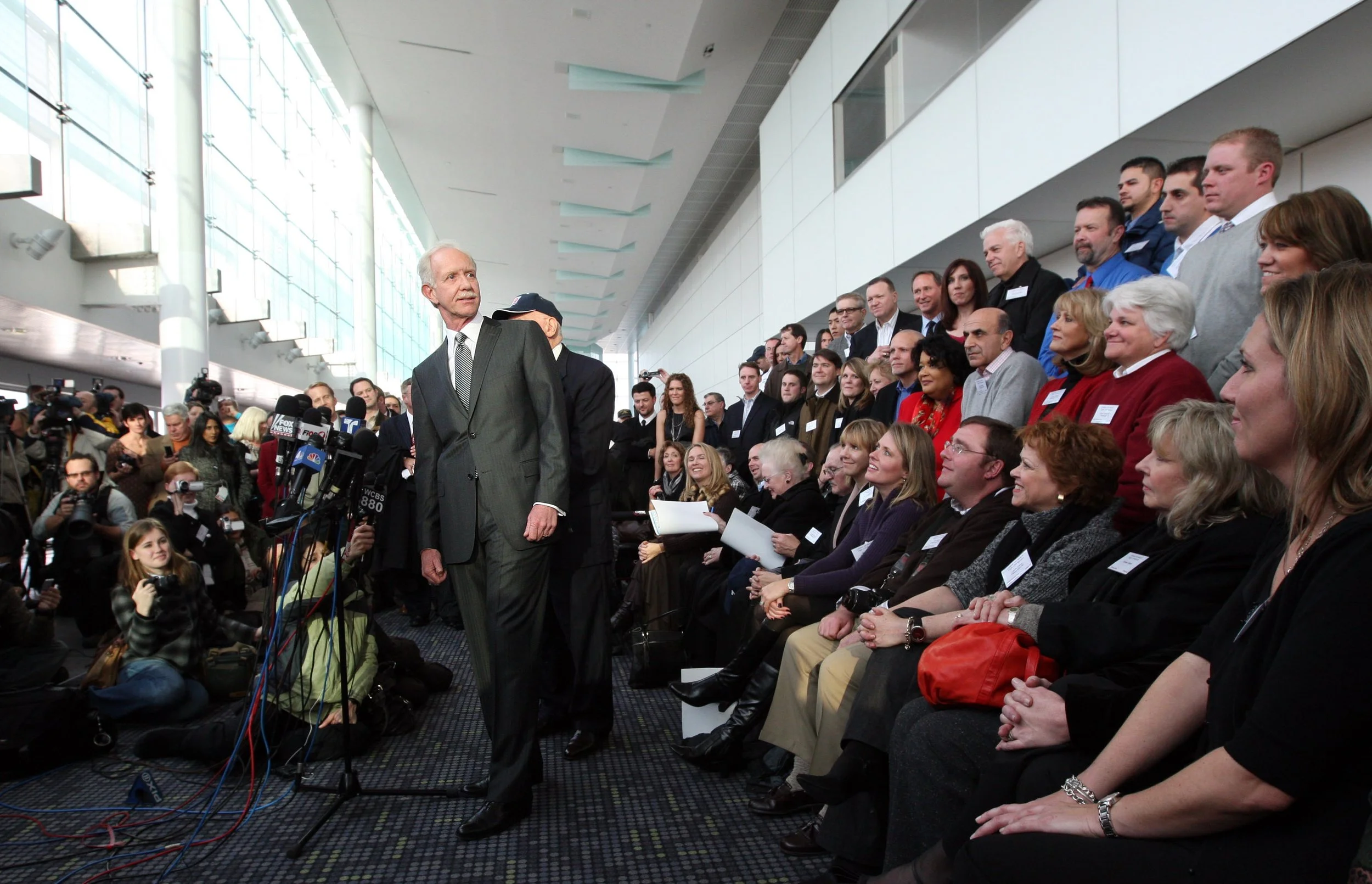  U.S. Airways Cpt. Chesley "Sully" Sullenberger looks back Friday, Jan. 15, 2010, at a group of Flight 1549 passengers he saved when he splash landed his jet in to the Hudson River a year ago. The Flight 1549 flight crew, passengers and first respond