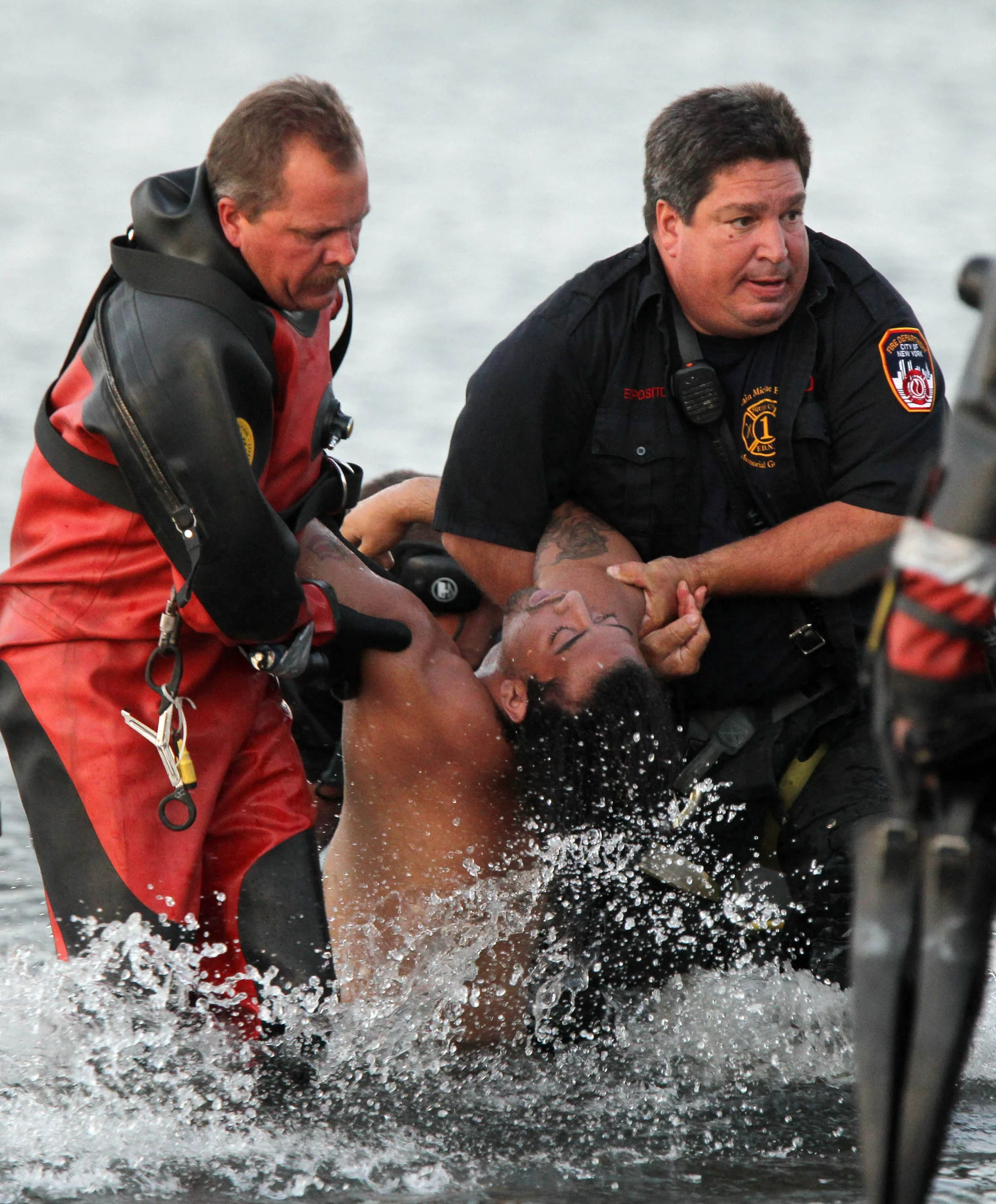  Emergency personnel pull a drowning victim from Gravesend Bay in Coney Island, Brooklyn, Friday, Sept. 2, 2011, near W37th Street and Bayside Avenue.  