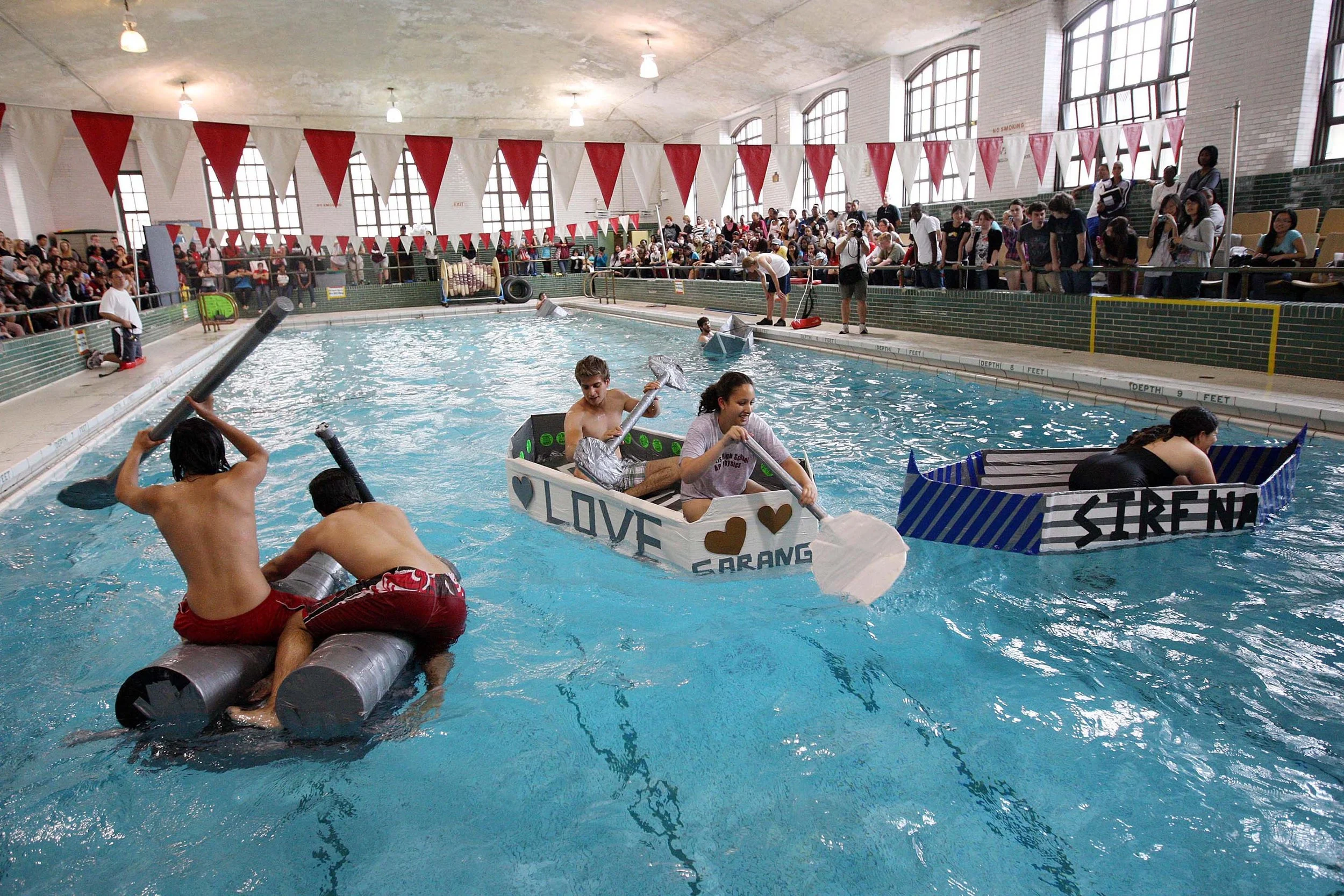  Curtis High School advanced placement physics students Jessica Lee and Joseph Carpenito, center, paddle their cardboard and duct tape "Love Boat" to victory in the school's pool during the 5th annual Curtis Cardboard Regatta Wednesday, June 10, 2009