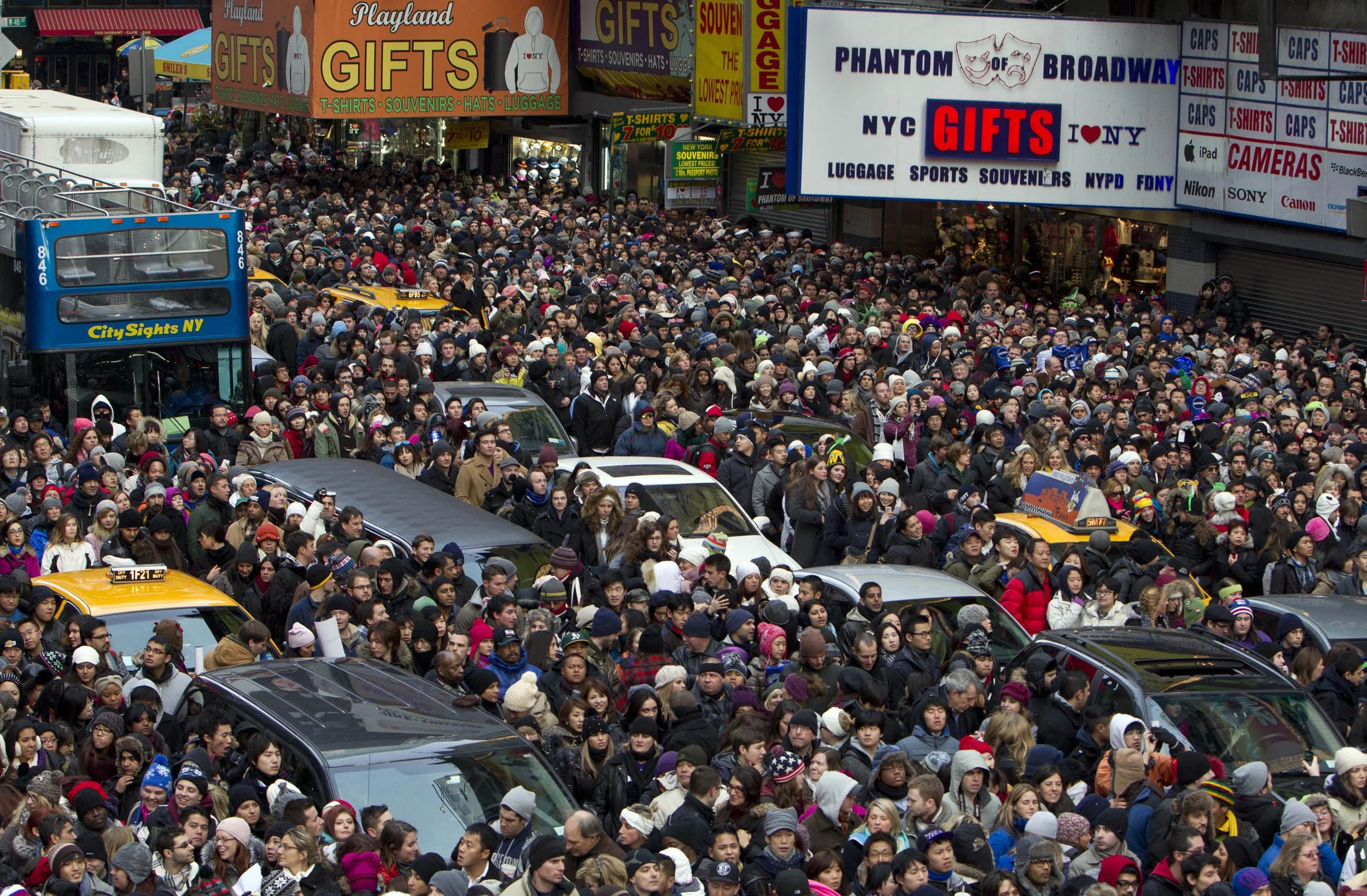  Cars and busses are trapped as revelers make their way down 7th Ave toward New York's Times Square for New Year's Eve celebrations Monday, Dec. 31, 2012.  