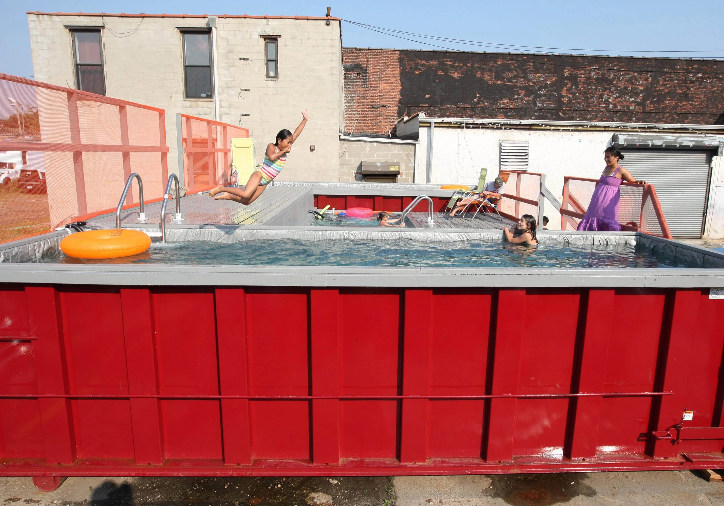  Tenzing Gyasel leaps into a dumpster converted into a swimming pool Thursday, July 16, 2009 in the Gowanus section of the Brooklyn borough of New York.  