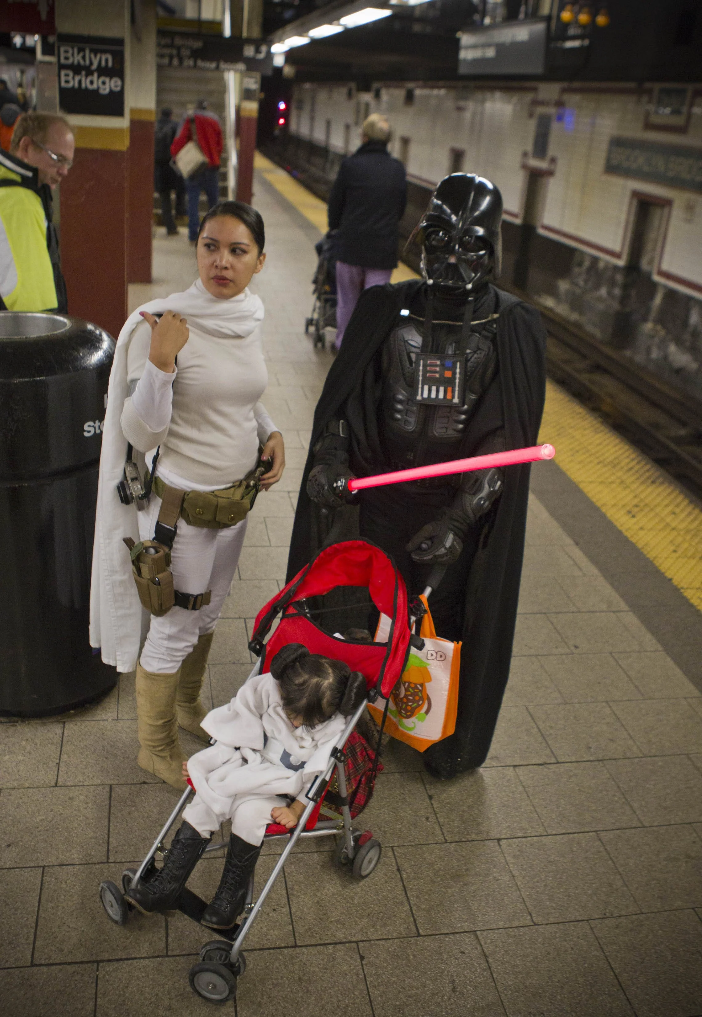  A family dressed as Star Wars characters for Halloween wait for the subway at the Brooklyn Bridge station Monday, Oct. 31, 2011, in New York.  