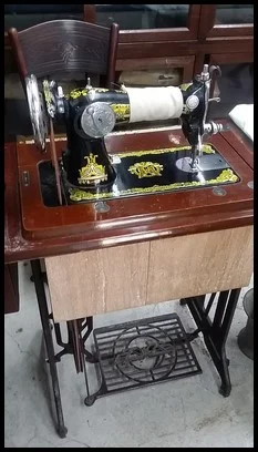 The tailor used a sewing machine for efficiency.