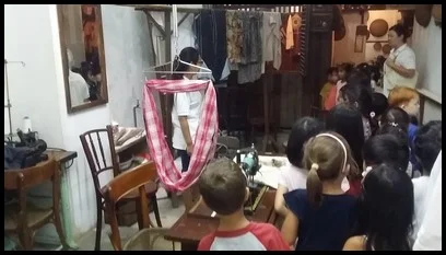 Babies were put in a sarong and the children had tricyles to play with while their parents worked at the sewing machine.