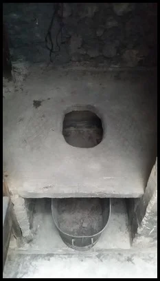 The hole in the ground was the toilet used in the past. The night soil collector would come by at night to collect all the pee and poop.