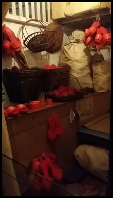 The room of a clog maker. A clog maker made the clogs he sold in the room that he sleeps in.