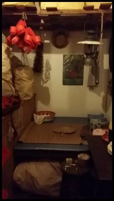 The room of a clog maker. A clog maker made the clogs he sold in the room that he sleeps in.