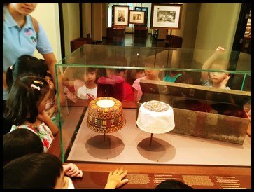  The children were shown the "songkok"- a cap commonly worn by Muslim males. 