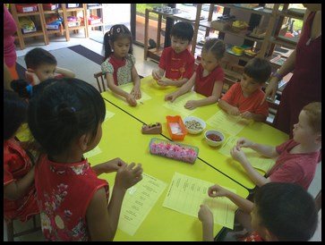  The children took turns putting the treats in the packets and taping them on their list of treats. 