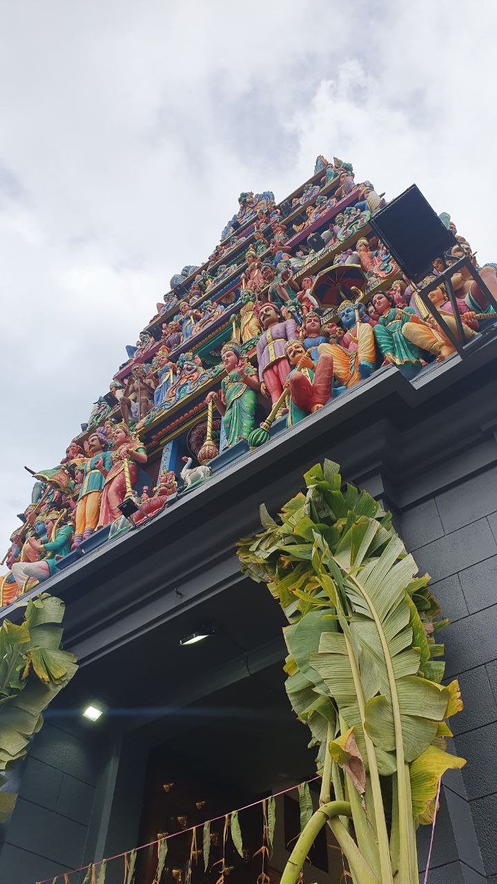  There is a monumental entrance tower at the entrance of a Hindu temple. It has six tiers covered with sculptures of Hindu deities.   