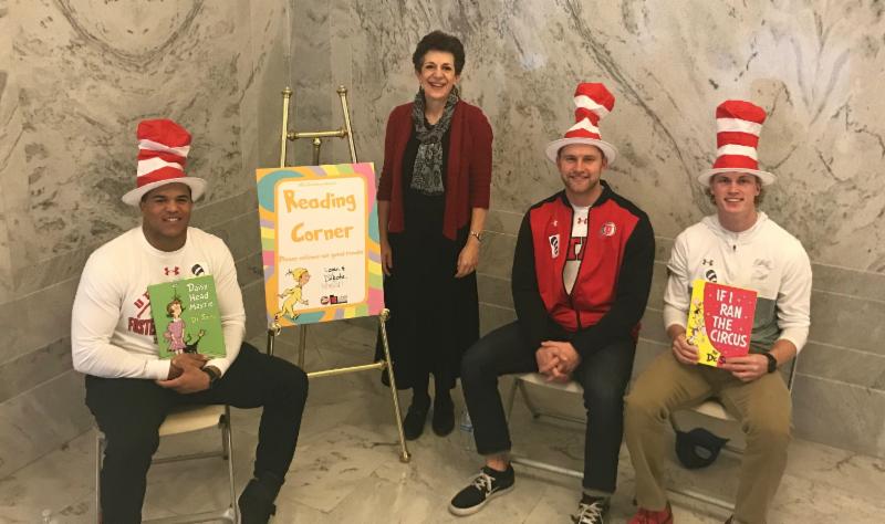 University of Utah football players Mason Woodward, Logan Bateman and Dakota Baker read to students at the Capitol.