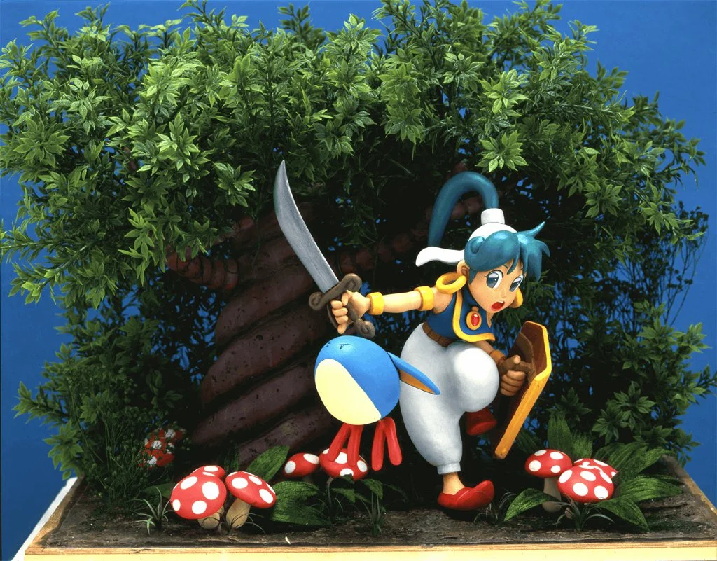 Questo delizioso modellino di Asha e Pepelogoo è servito come soggetto per la cover della cartuccia originale per Megadrive.