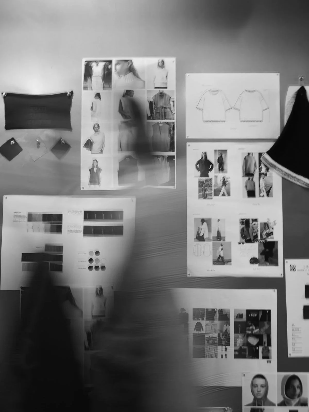 Fashion design board with sketches, photos, fabric samples, and mood images, pinned to a wall.