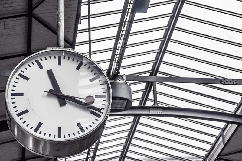 a black and white clock in a large building